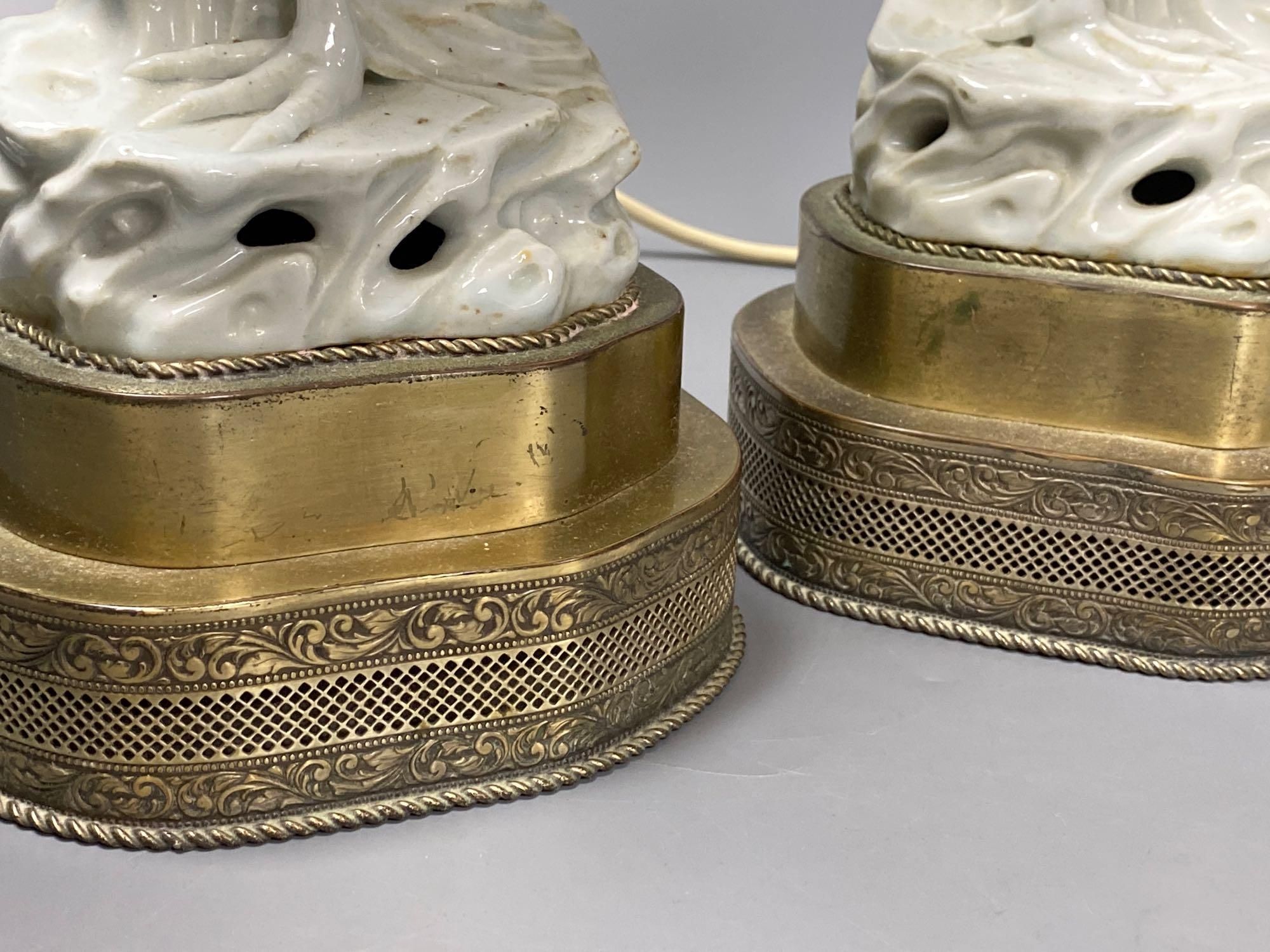 A pair of blanc de chine cockerel lamps, total height 64cm
